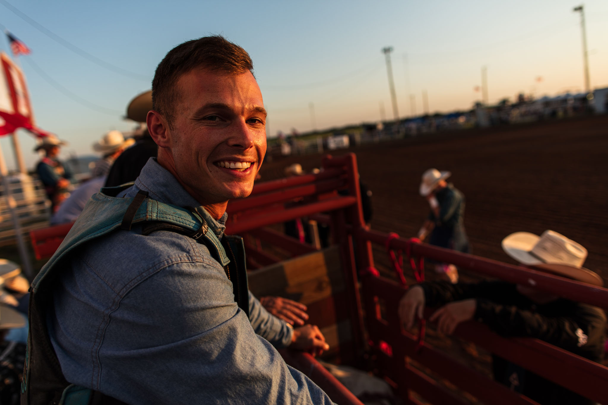 Smiling cowboy behind the chutes