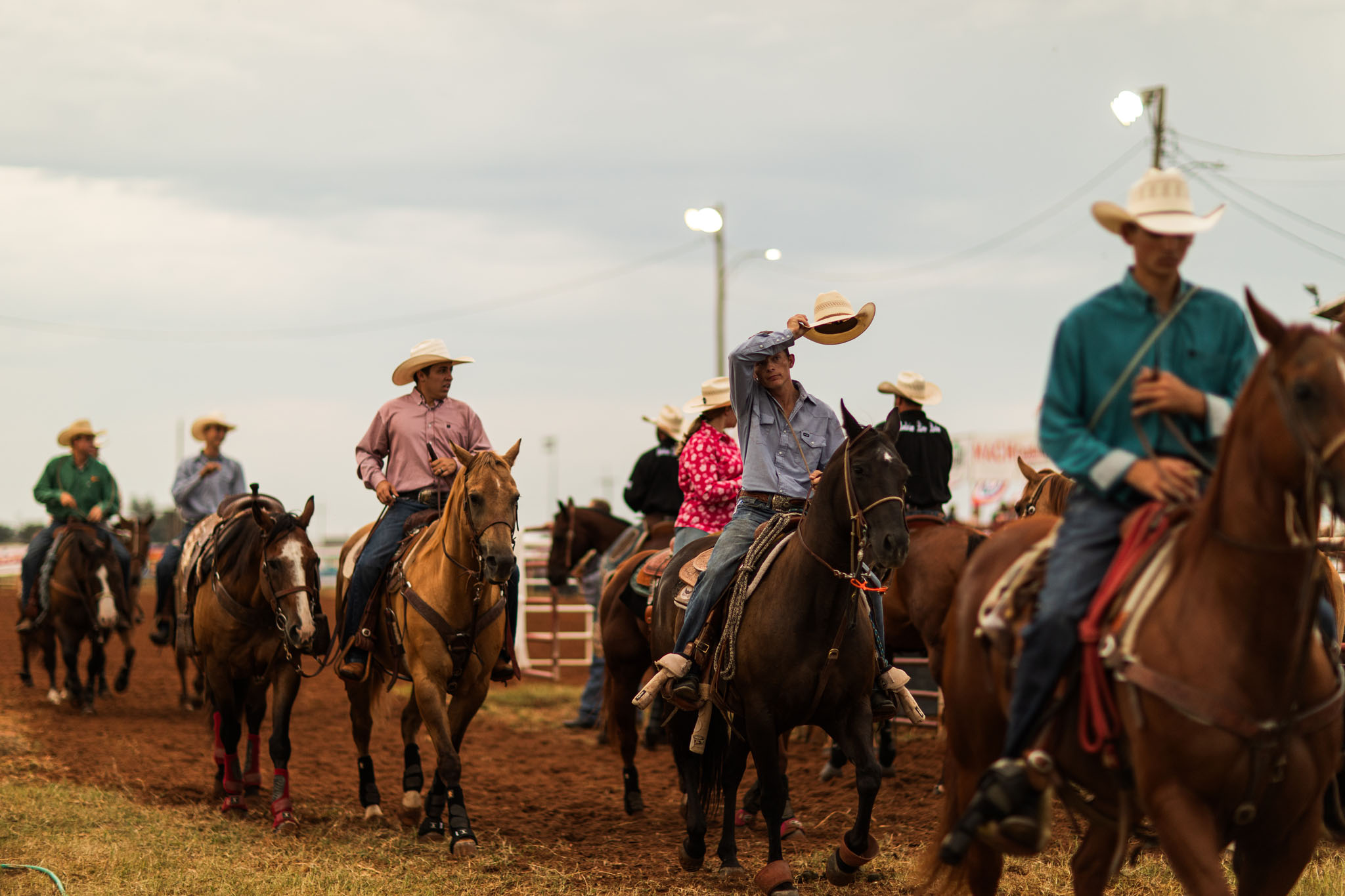 Riders on horseback filing into the arena for the grand entry