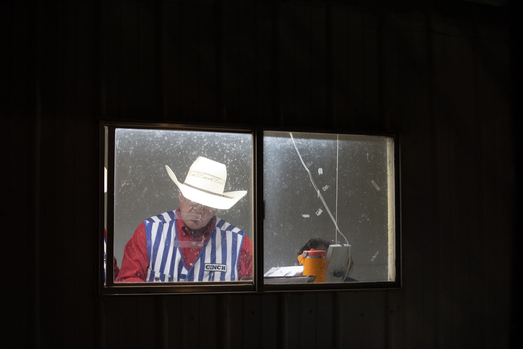 Announcer framed in the window of the booth