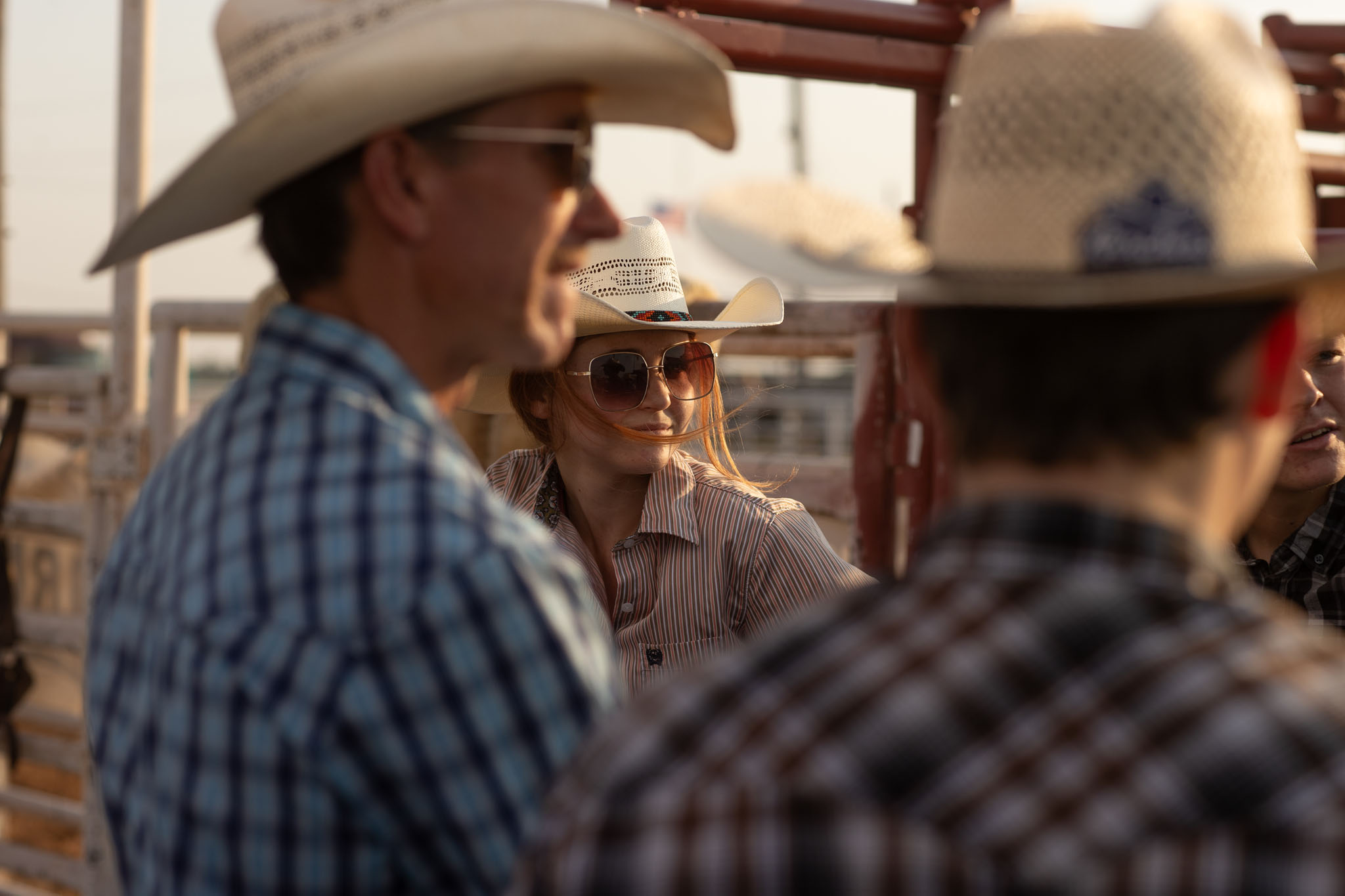 Cowboys talking along the rail