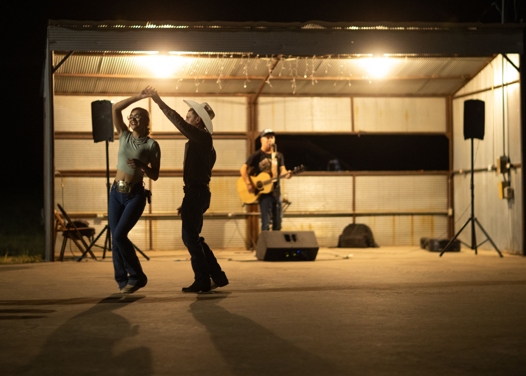 Couple dancing under the lights at the rodeo dance