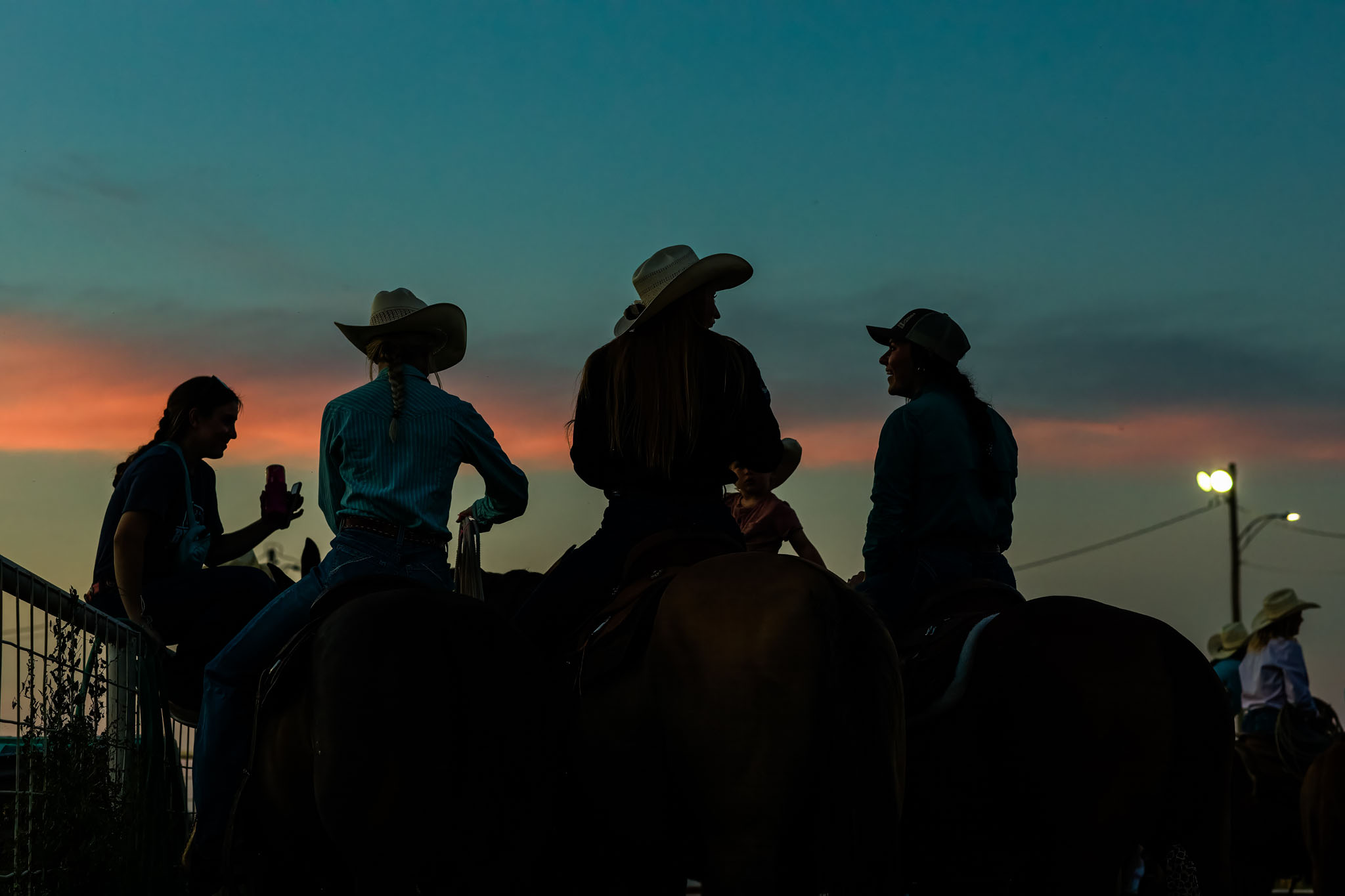 Cowboys on horseback silhouetted at blue hour