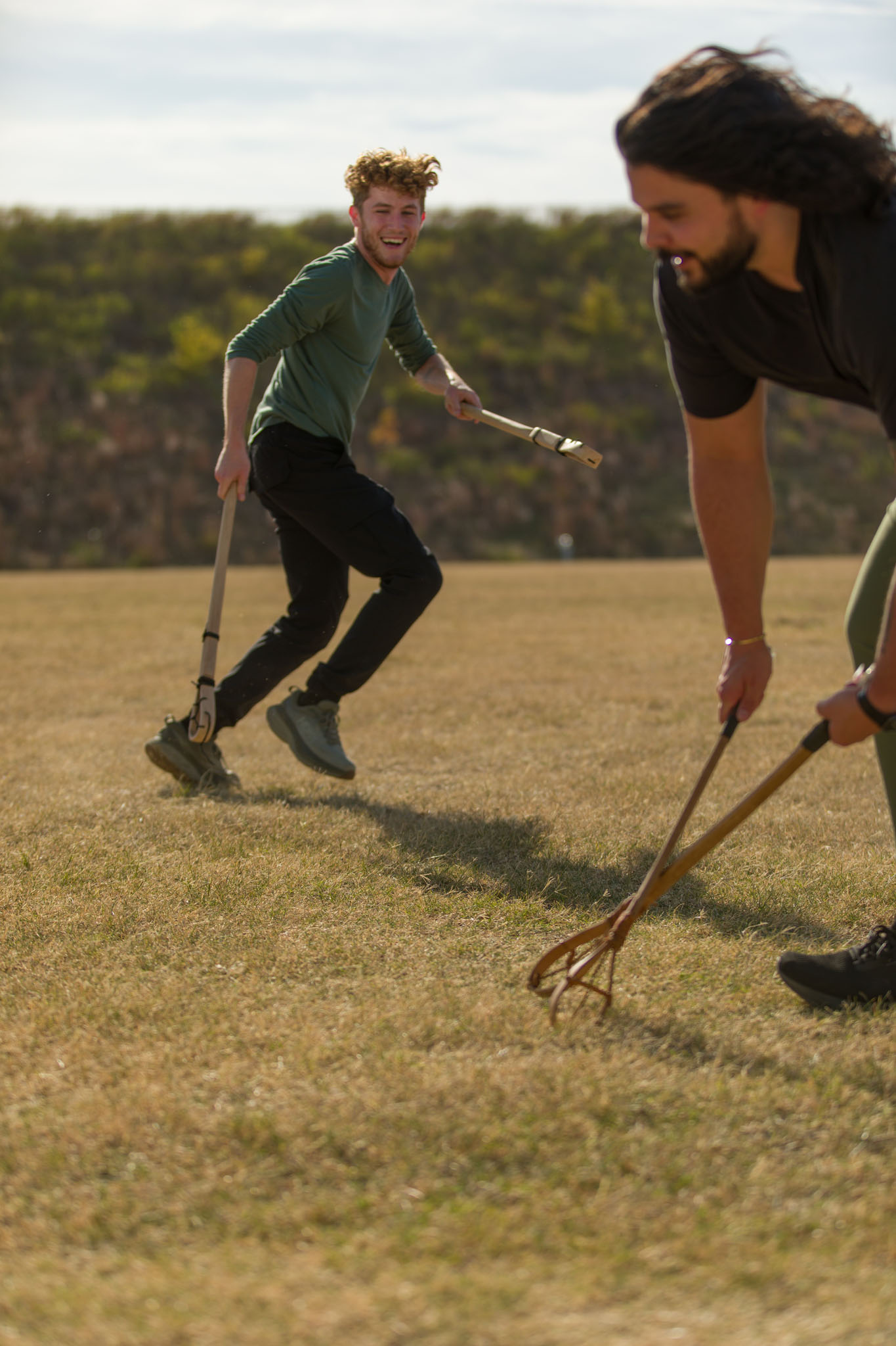 Young men playing stickball on an open field
