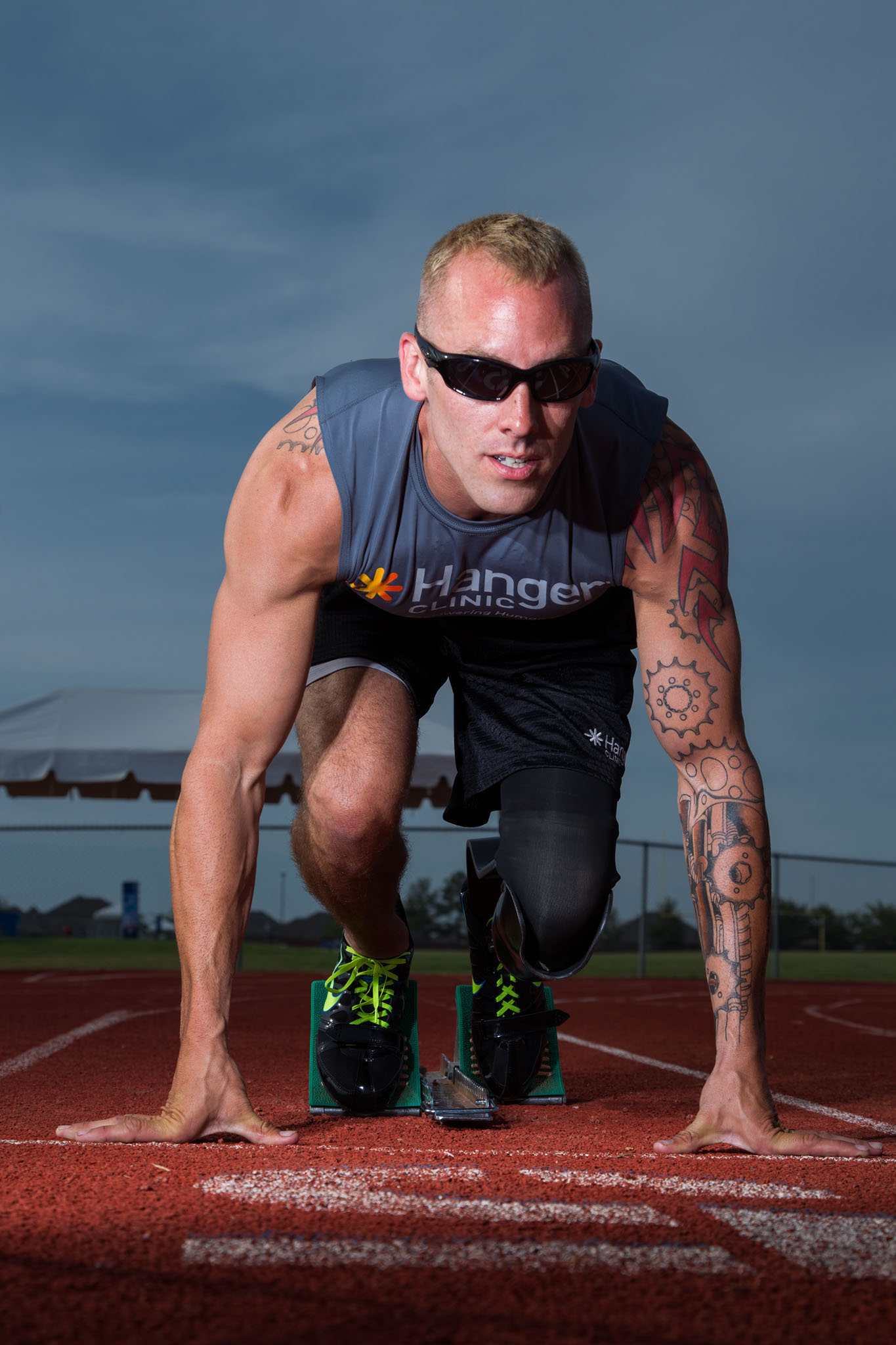 Sprinter on running blades set in the starting position on the track