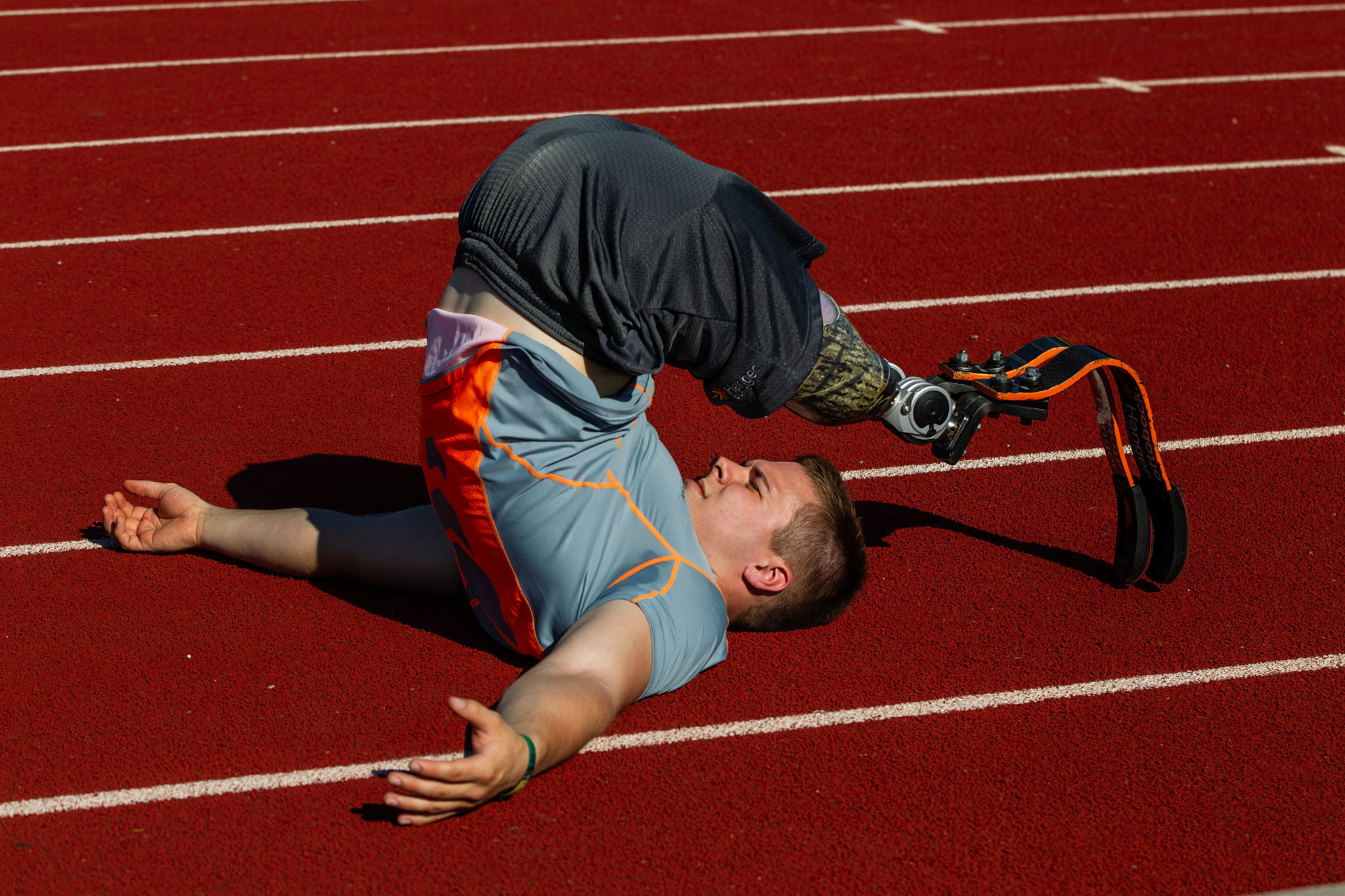 Athlete rolling on the track after a race