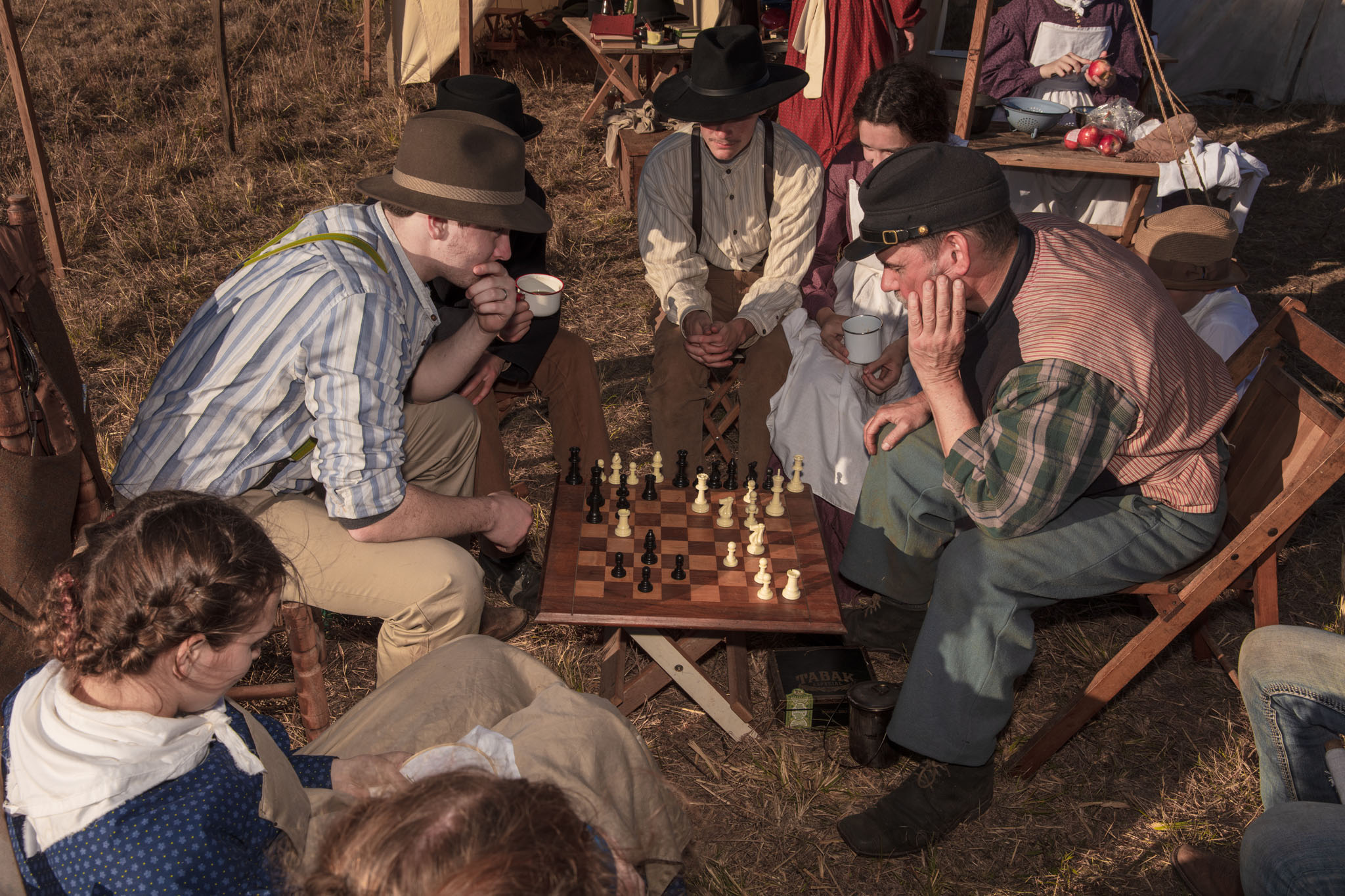 Reenactors playing chess in camp