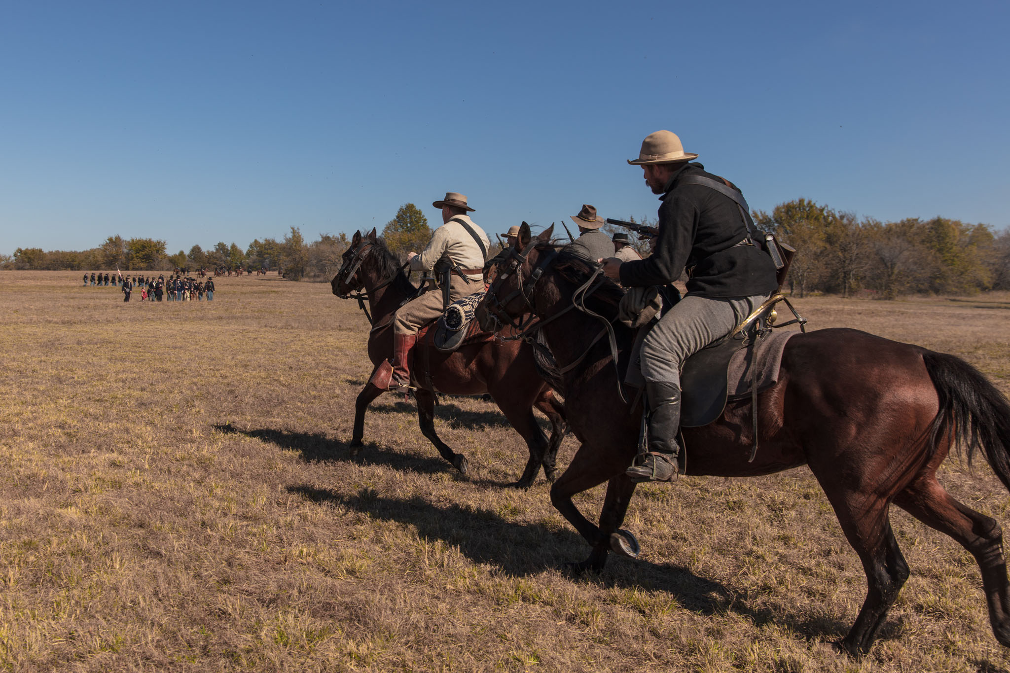 Cavalry reenactors riding across the open prairie
