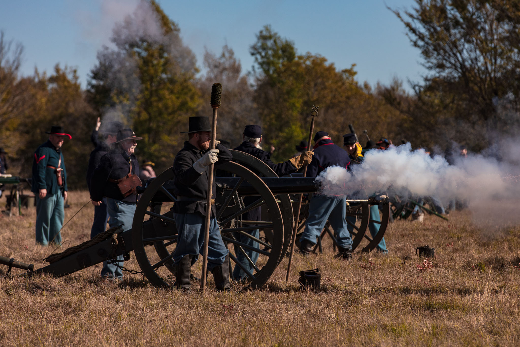 Union artillery crew firing a cannon in a cloud of smoke