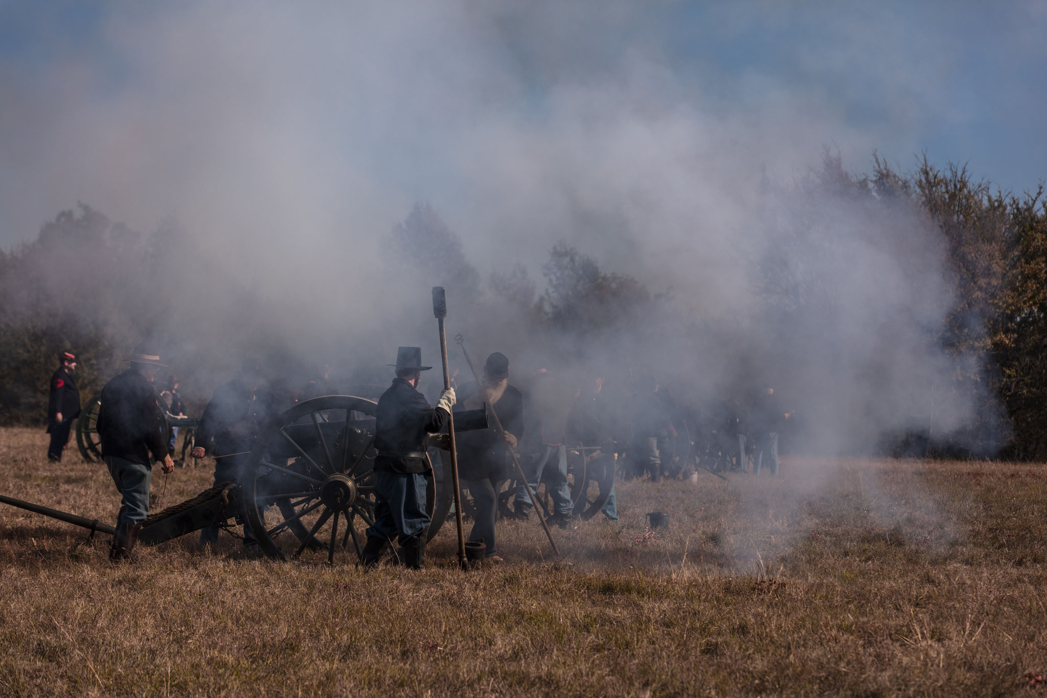 Cannon smoke drifting over the artillery line