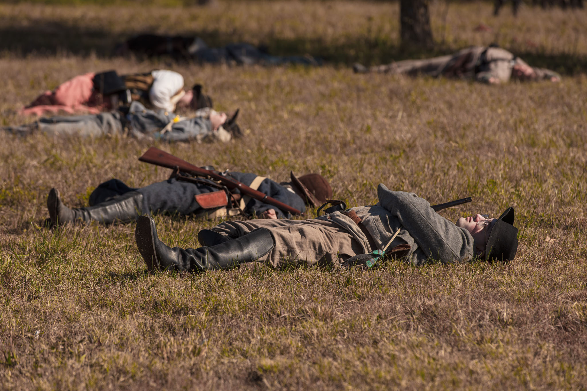 Reenactors lying in the grass as casualties