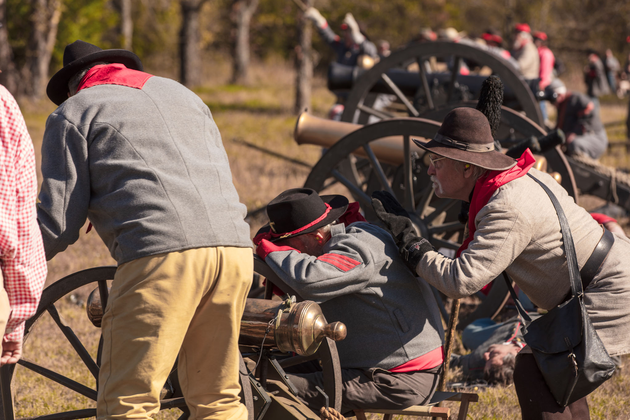 Artillery crew in gray loading a cannon