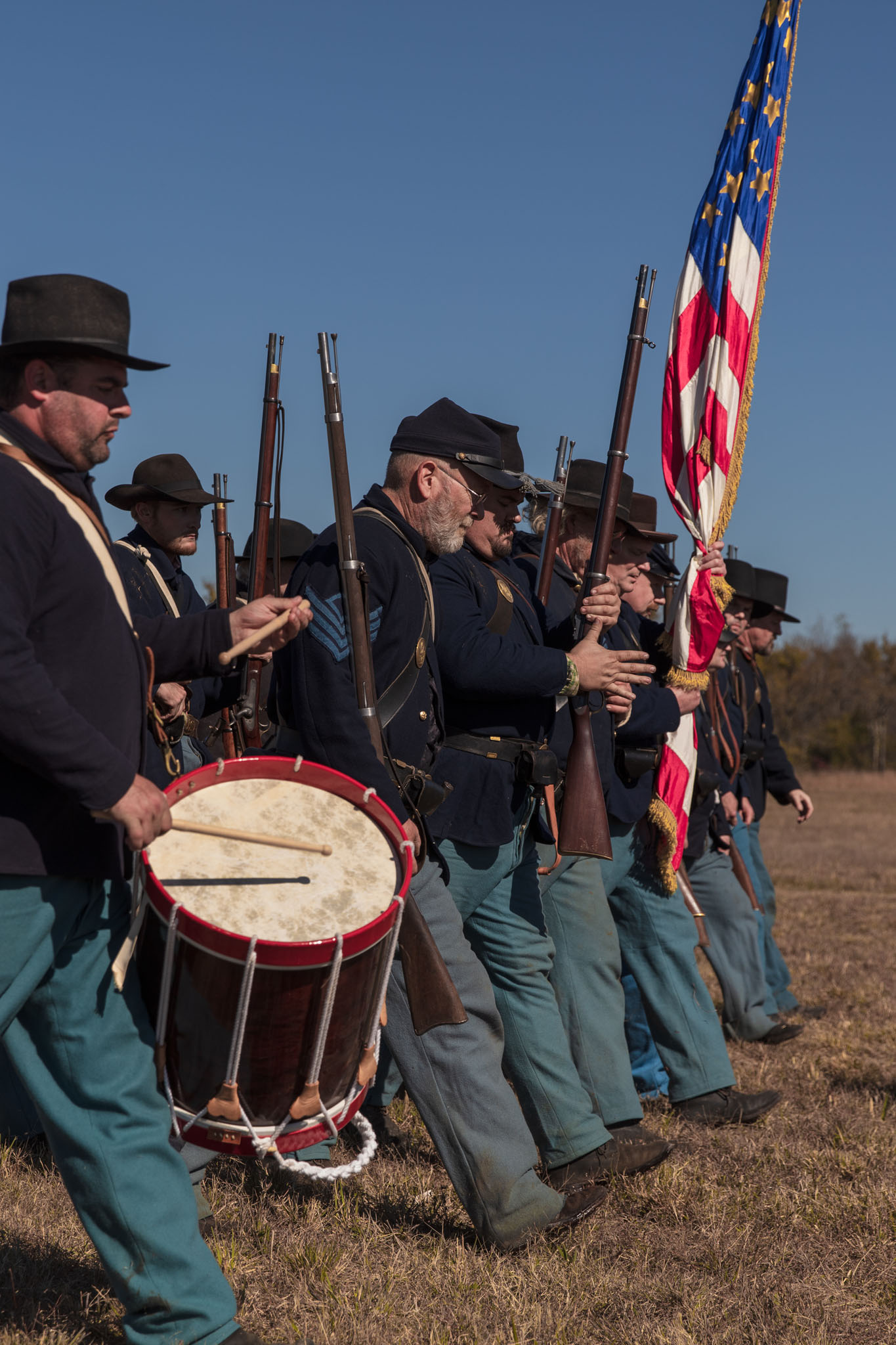 Union drummer and color guard with rifles and flag