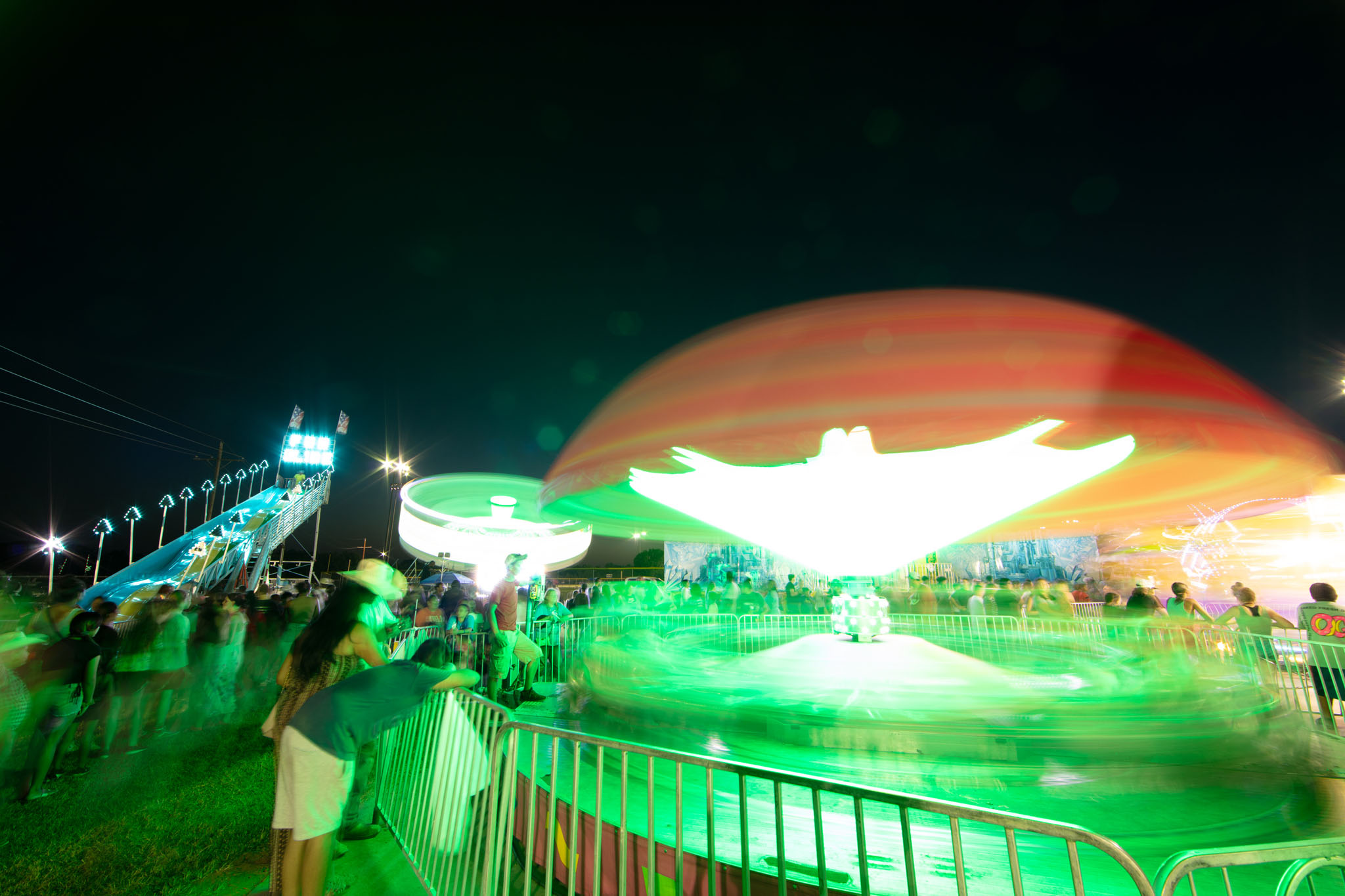 Carnival rides lit in green and red at night