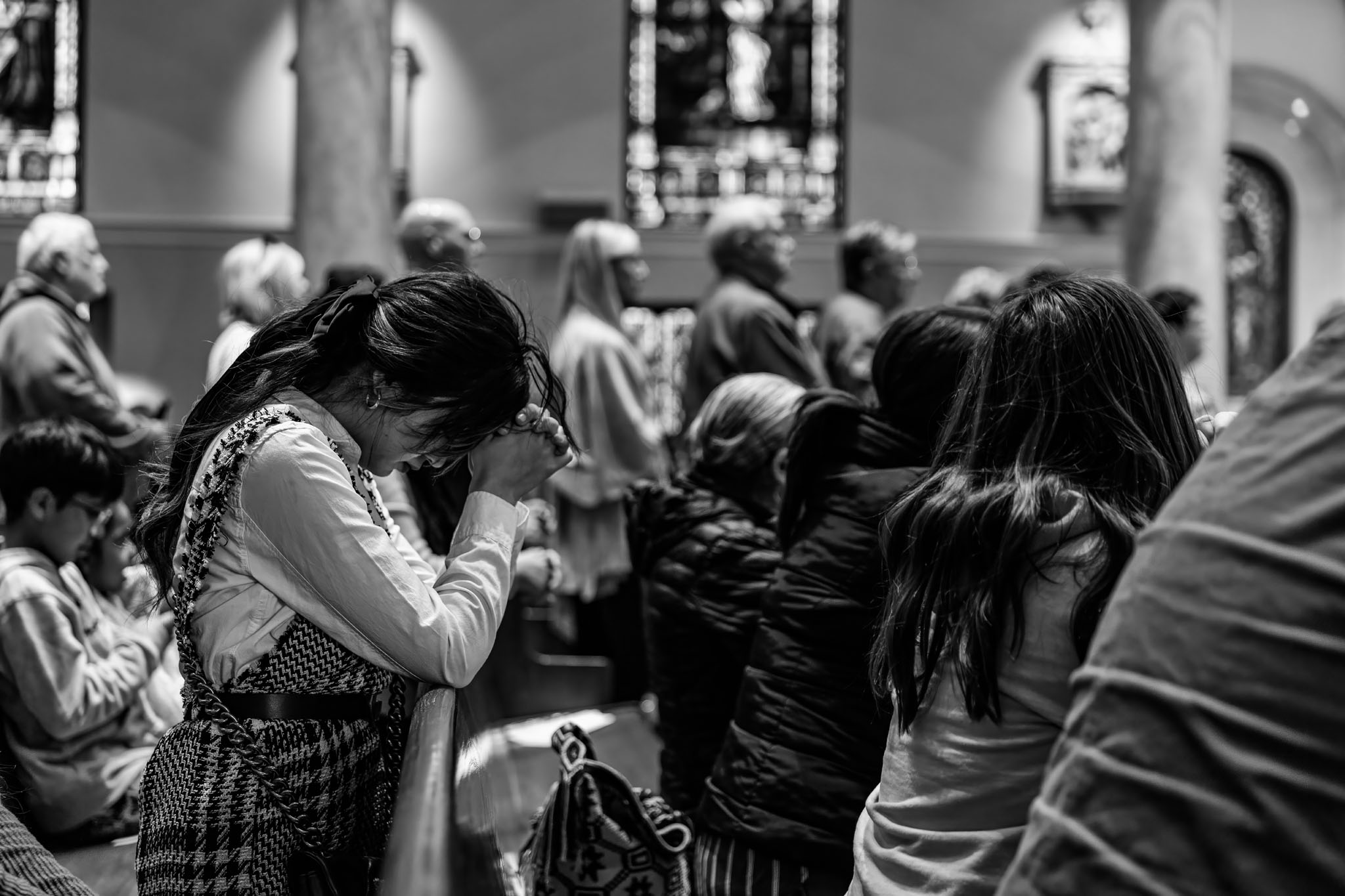 Worshippers bowing their heads in prayer during the service