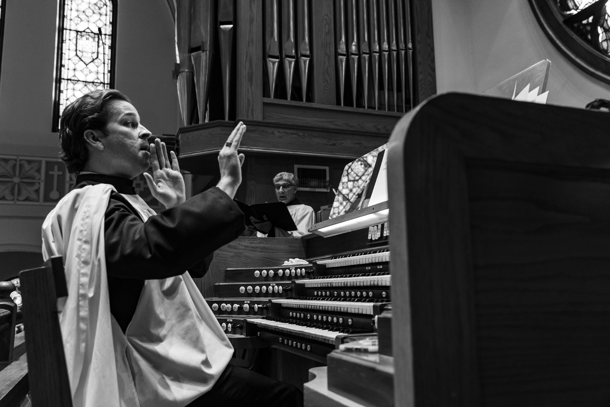 Woman singing beside the pipe organ during the service