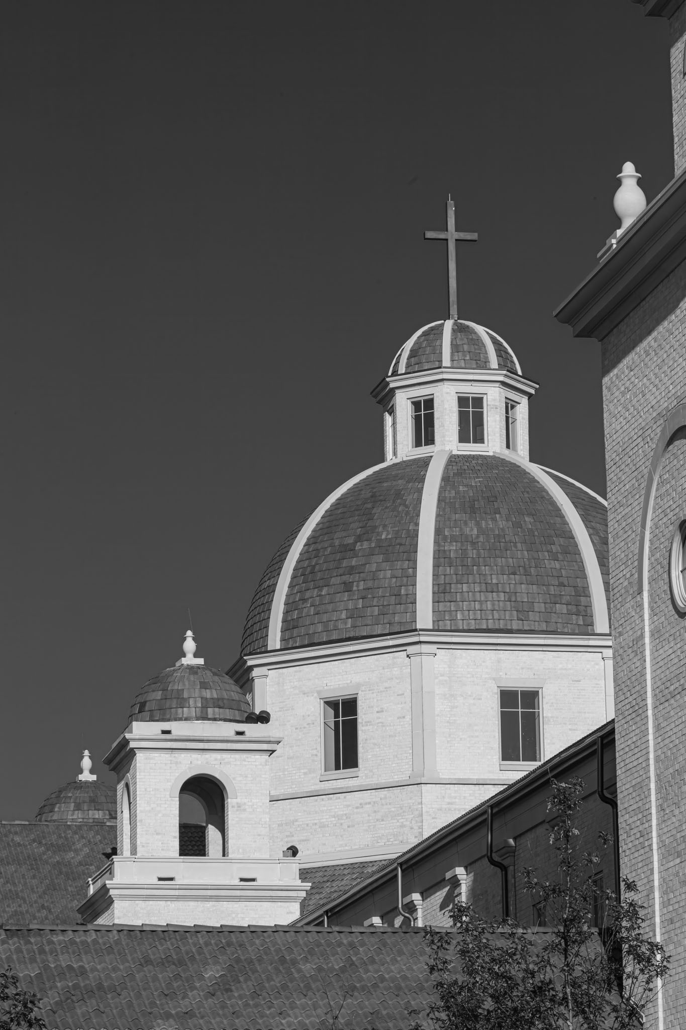 The shrine’s white dome and bell tower against a dark sky