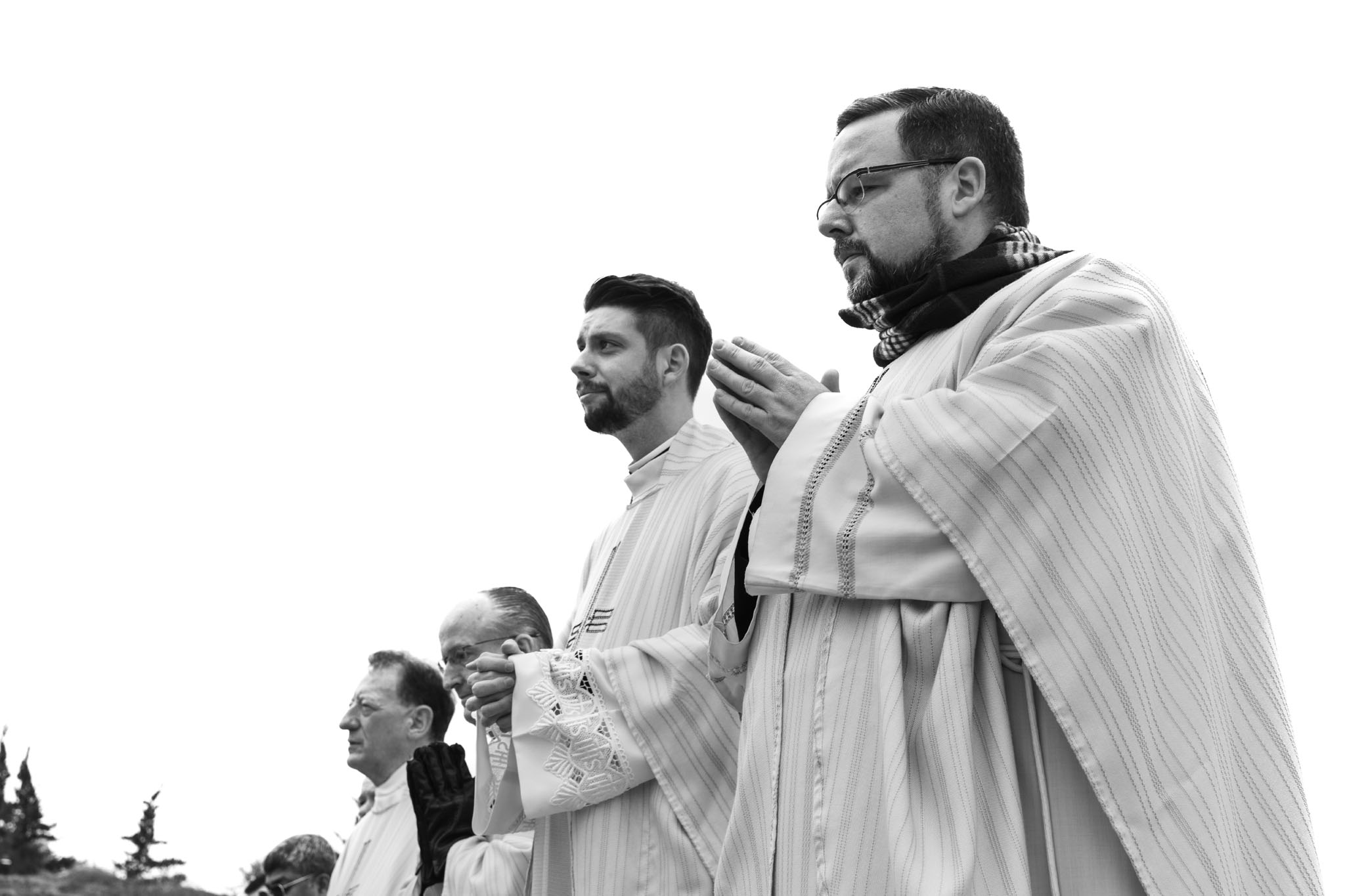 Priests in vestments gathered outdoors during the dedication